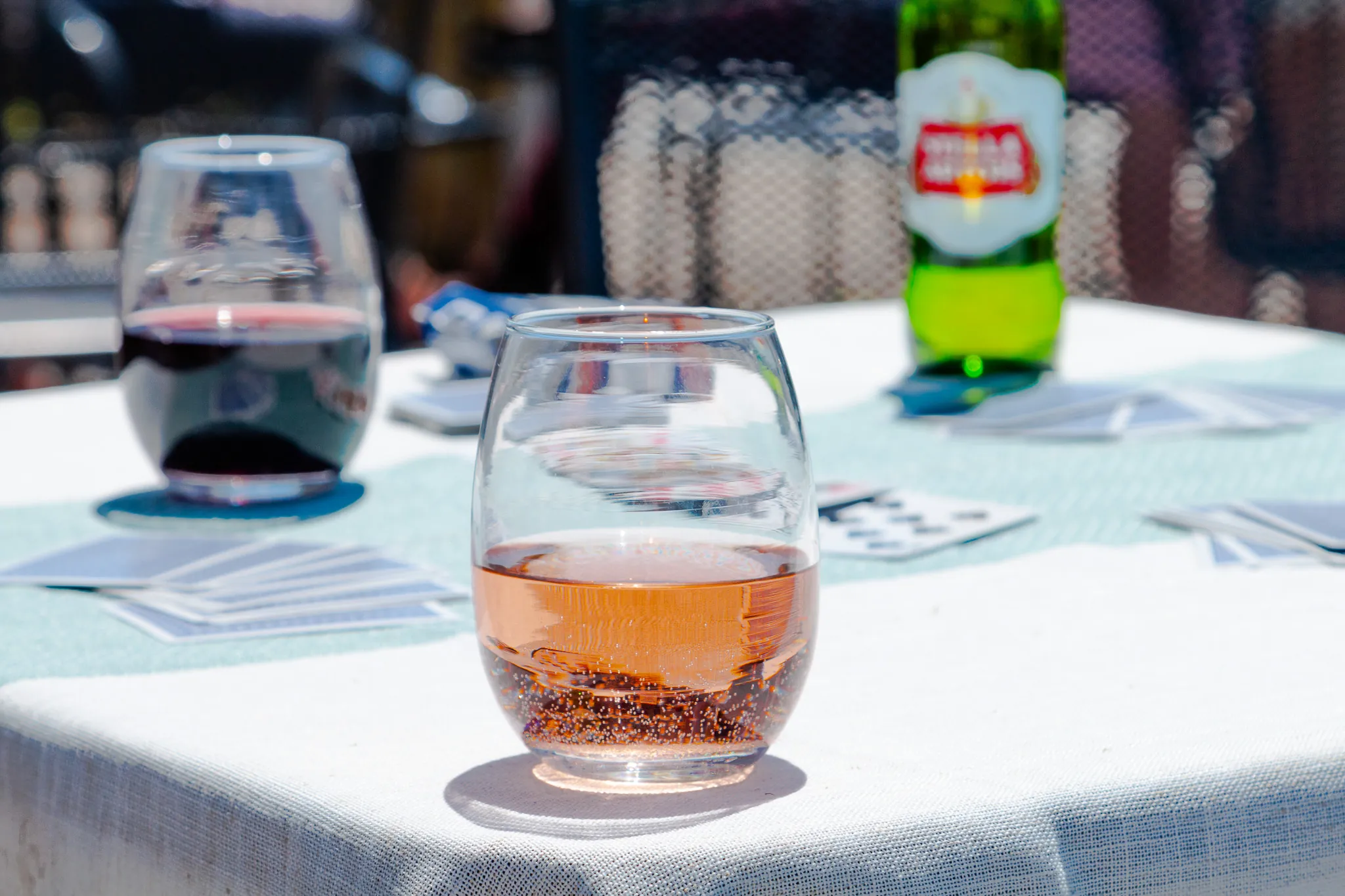 Red wine, rosé and a beer on a patio table